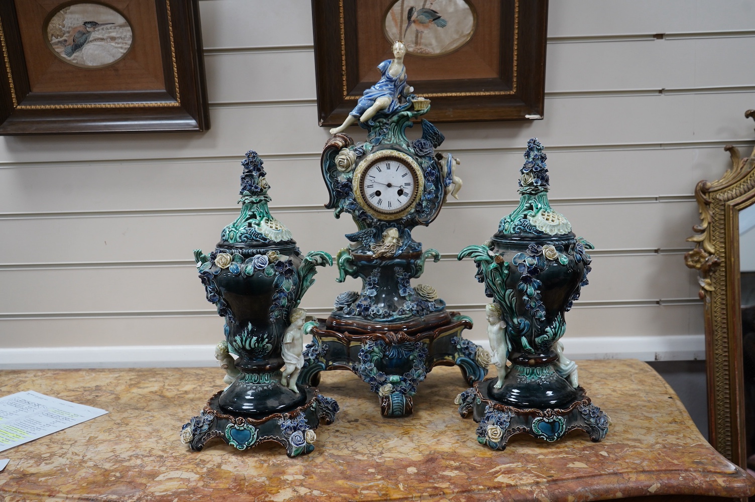 A Rorstrand pottery figural clock garniture with enamel dial and floral encrusted decoration, largest 57cm high. Condition - poor